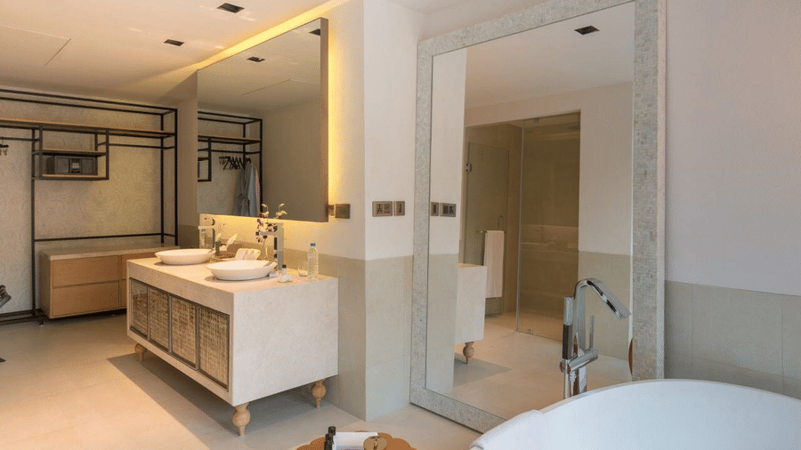 Immaculate bathroom interiors with two large mirrors and toiletries