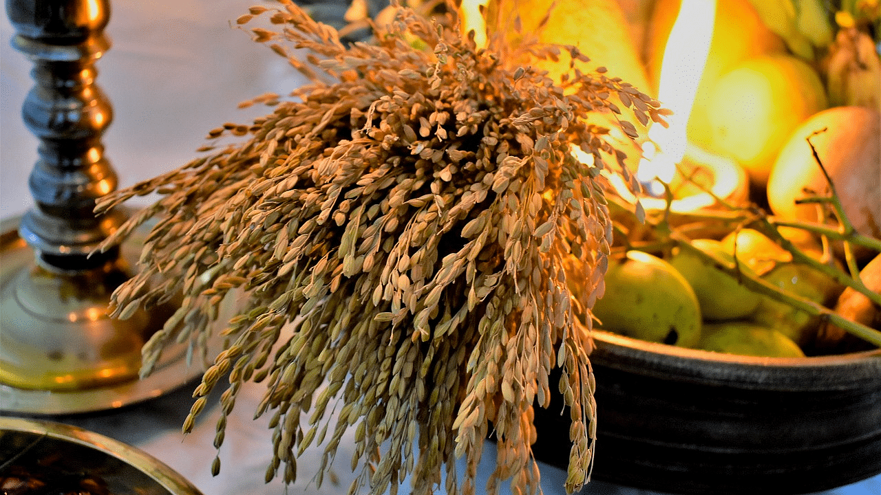 image of a basket with a lots of fruits and an earthen lamp brightly lit that is made for Vishu festival in Kerala.