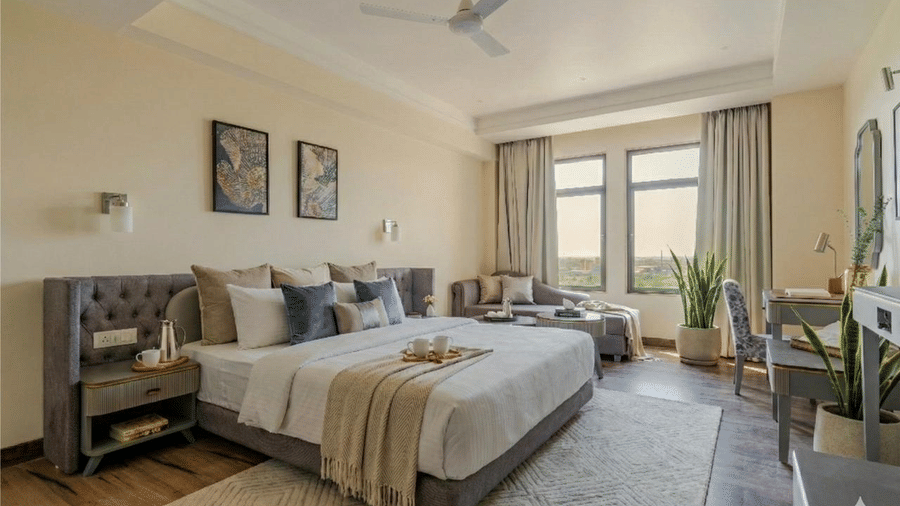 Full view of the Executive Suite featuring a double bed and a textured rug placed under it at Essentia Luxury Hotel and Convention, Nagpur.