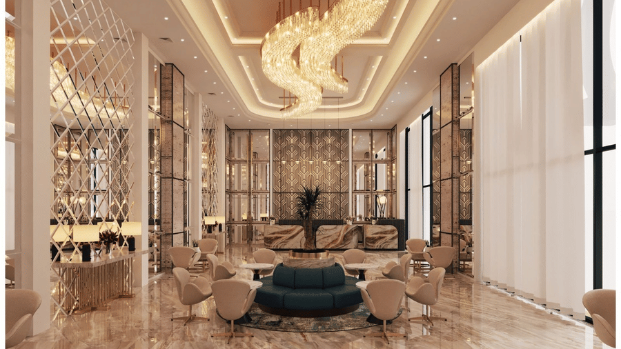 An expansive lobby area with ample of natural lighting coming from the exterior, featuring a beautiful chandelier hanging from the ceiling above the waiting area at Essentia Luxury Hotel and Convention, Nagpur.