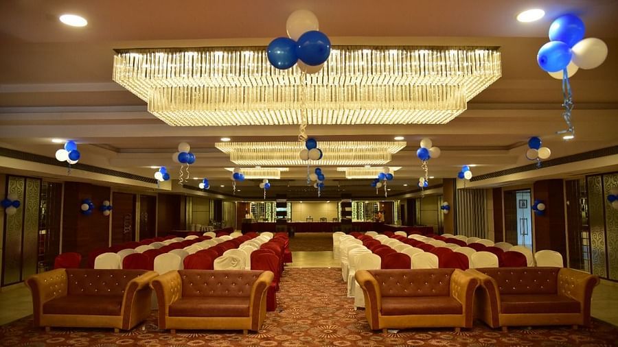 A decorated banquet hall at Rang Lords Inn, with arranged seating and festive balloons, prepared for a celebration or event