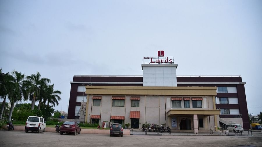 Exterior view of Rang Lords Inn, Bharuch, showing the building's facade and surrounding grounds under a cloudy sky