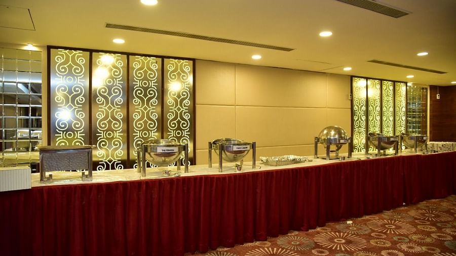 Buffet service area at Rang Lords Inn, featuring food stations and decorative panels, ready for event dining