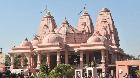 A large, intricate pink temple with multiple domes.