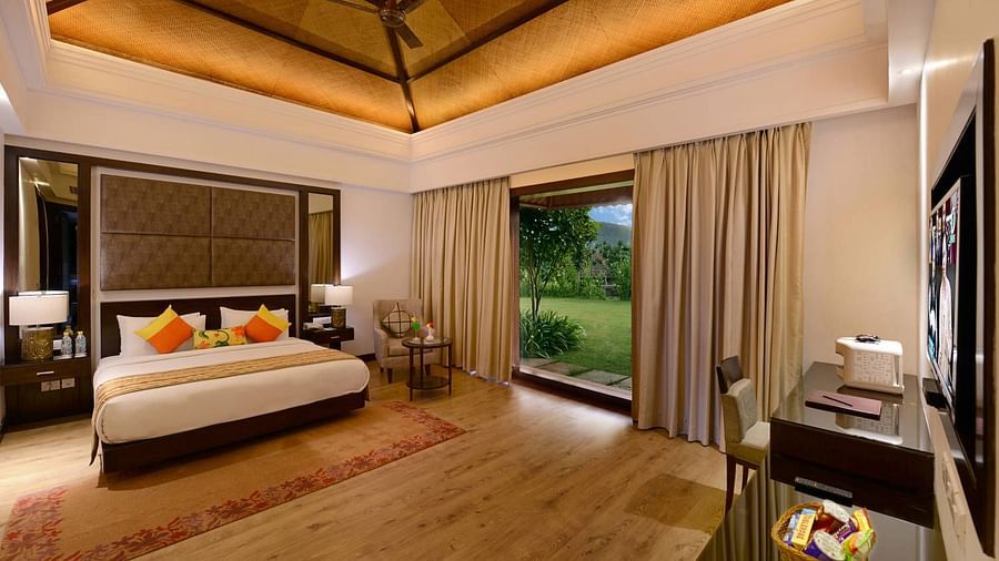A king size bed with floor to ceiling window at the Presidential suite - The Ananta Udaipur 