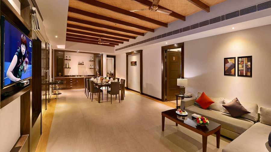 A overview of the living room inside Presidential suite showcasing sofa and a dining table - The Ananta Udaipur