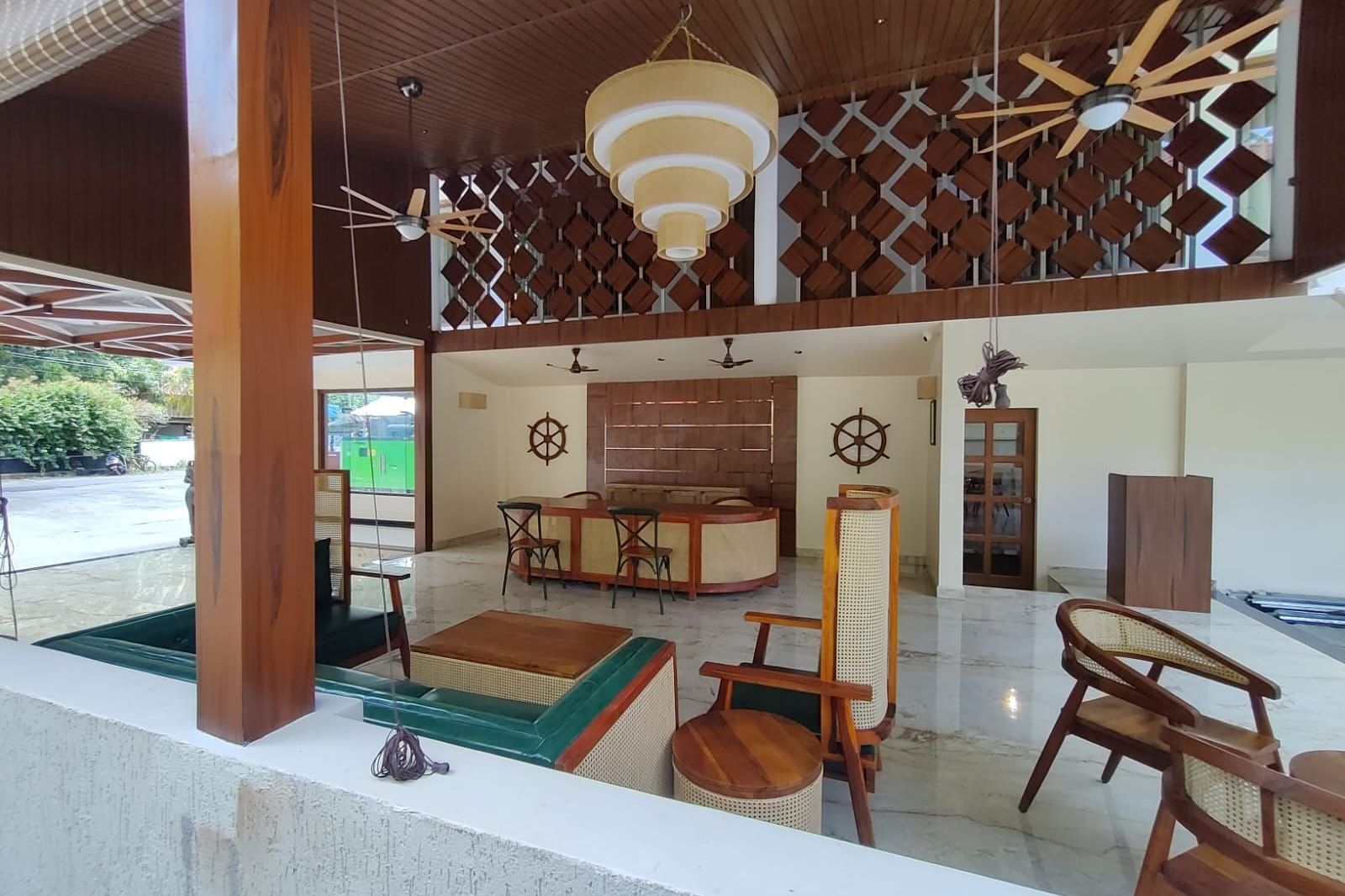 Image of an open air dining section at the resort featuring a decor made out of wood  | Arina Island Resort