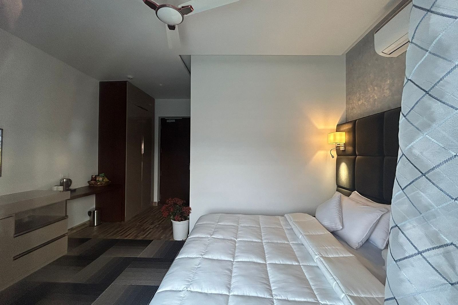 a deluxe room with modern interiors featuring a double bed at Eminence The Corbett