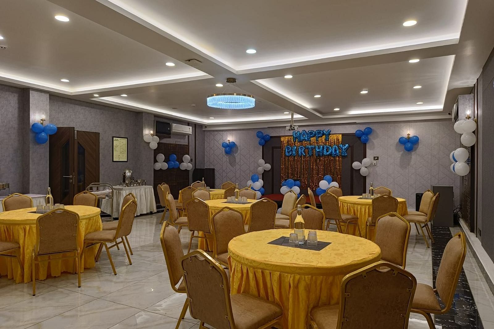 event hall with yellow chairs and tables at Hotel Eastern Gate, Port Blair