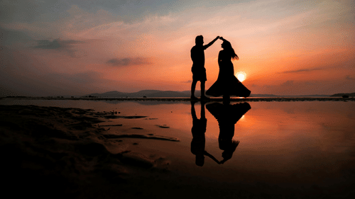 a couple posing for a picture in Chidiya Tapu with the sun setting in the background