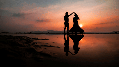a couple dancing on the Chidiya Tapu beach with the sun setting in the background
