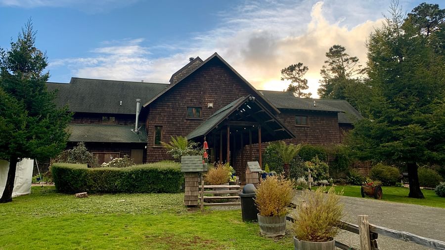 A rustic resort surrounded by greenery and a cloudy sky - Brewery Gulch Inn & Spa