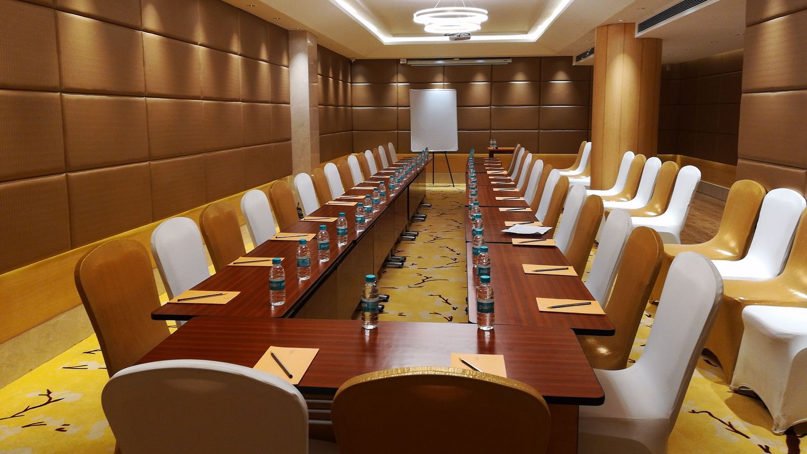 a meeting hall with a long rectangular table with chairs surrounding it - Hotel Fountain Tree By TGI - JP Nagar, Bangalore