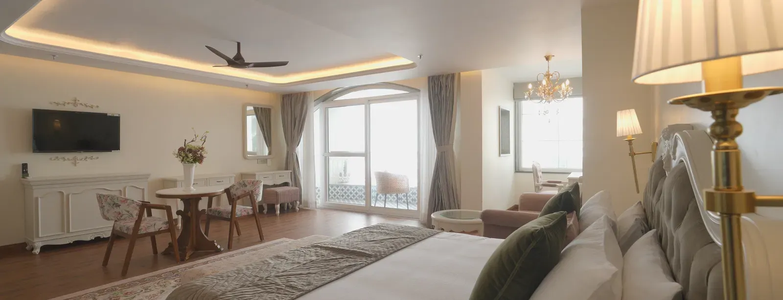 Luxury suite featuring a queen size bed, soft lighting, and refined decor - Mayfair Cafe & Suites, Dalhousie