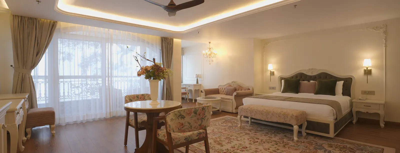 Spacious suite with queen size bed, wooden floors, and soft ceiling illumination - Mayfair Cafe & Suites, Dalhousie