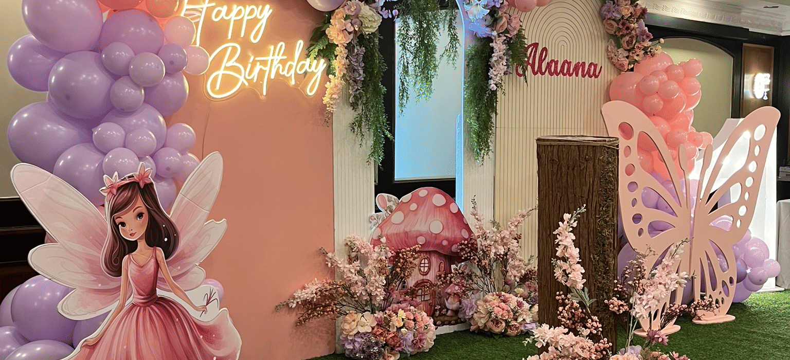 Indoor event setup with floral decorations and balloons at Marco Polo Hotel.