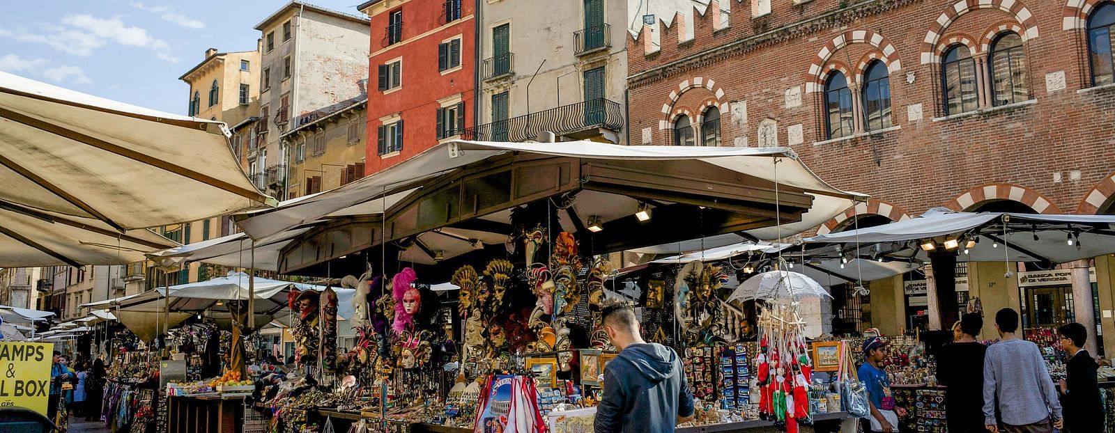 image of a street shop selling souvenirs to tourists along with other shops around it  