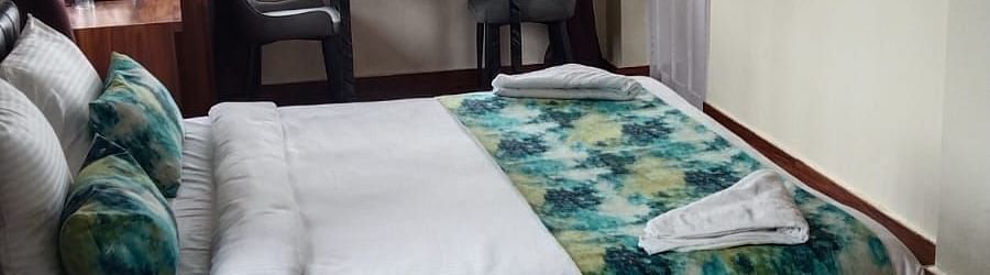 Side view of the double bed inside Deluxe room - Ecotel Kolkata