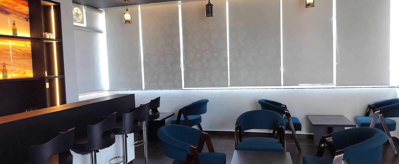 image of the forest ground cafe with blue coloured chairs - Eminence The Corbett
