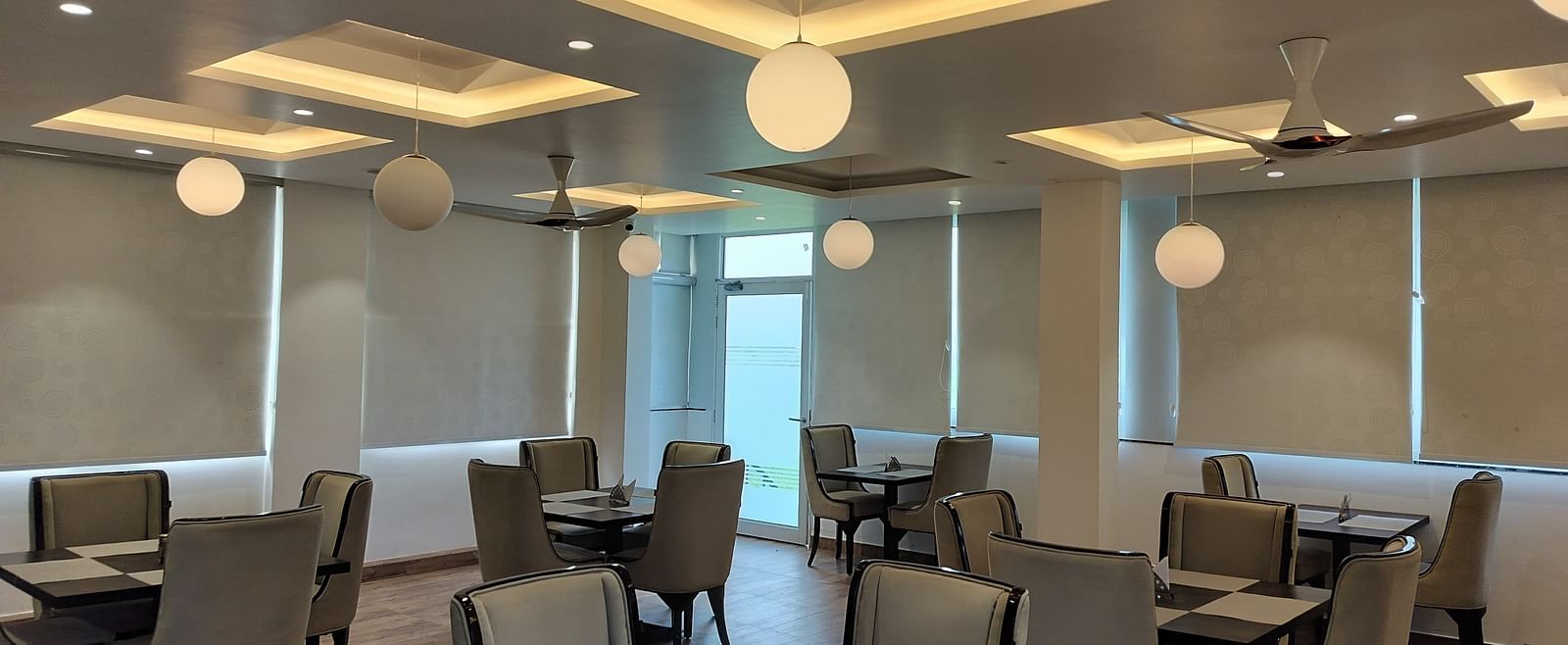 full view image of the dining area at panther's perch with window shades rolled down - Eminence The Corbett