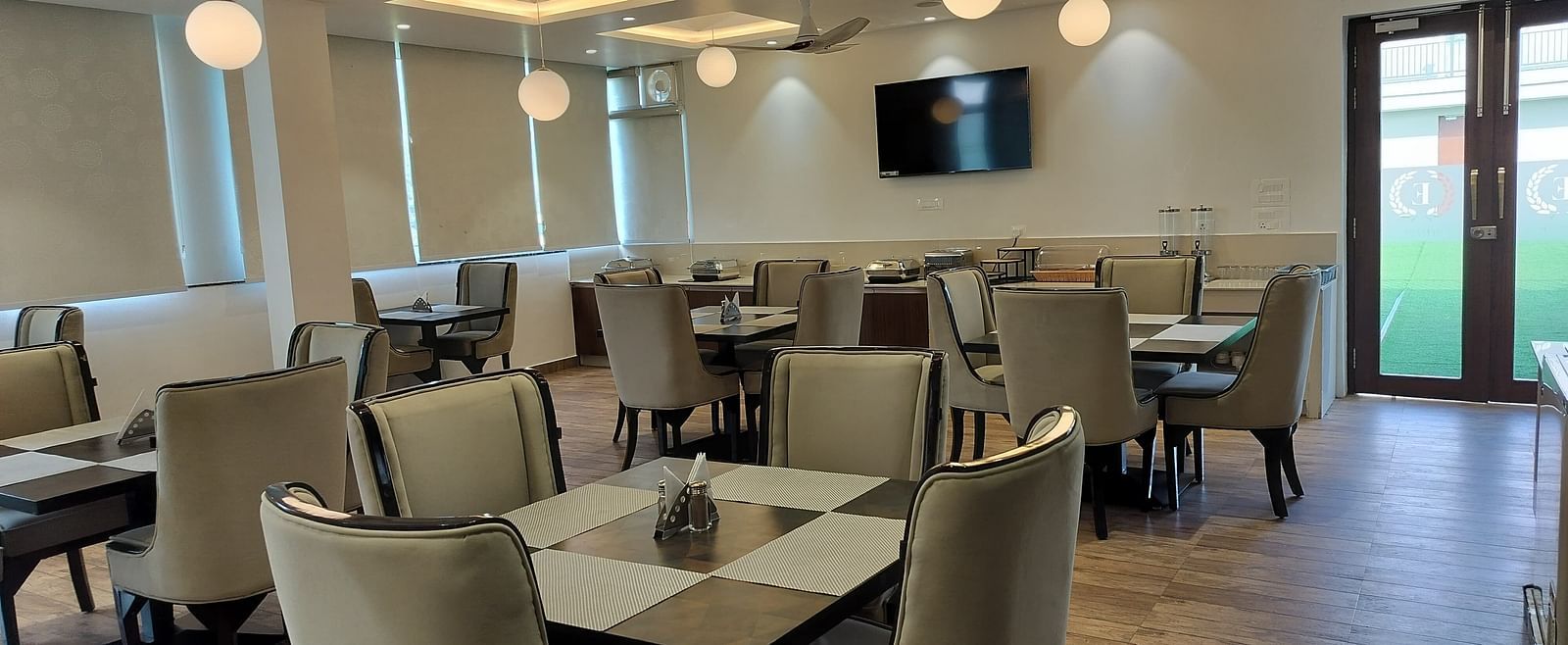 image of the dining area at panther's perch with grey coloured cushioned chairs - Eminence The Corbett