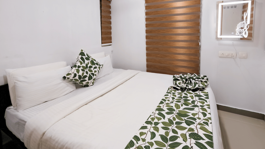 A bright white bedroom with modern window blinds, a vanity mirror, and air conditioning - Ibex Resorts, Malampuzha (Kava Eco Camp and Caravan Park)
