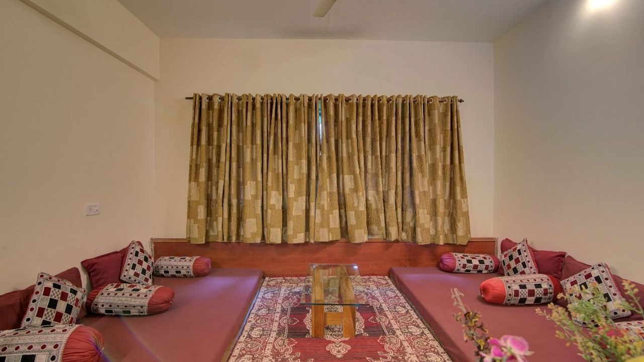 a bedroom with an indian style bed on the ground - Camel Valley Resort, Igatpuri