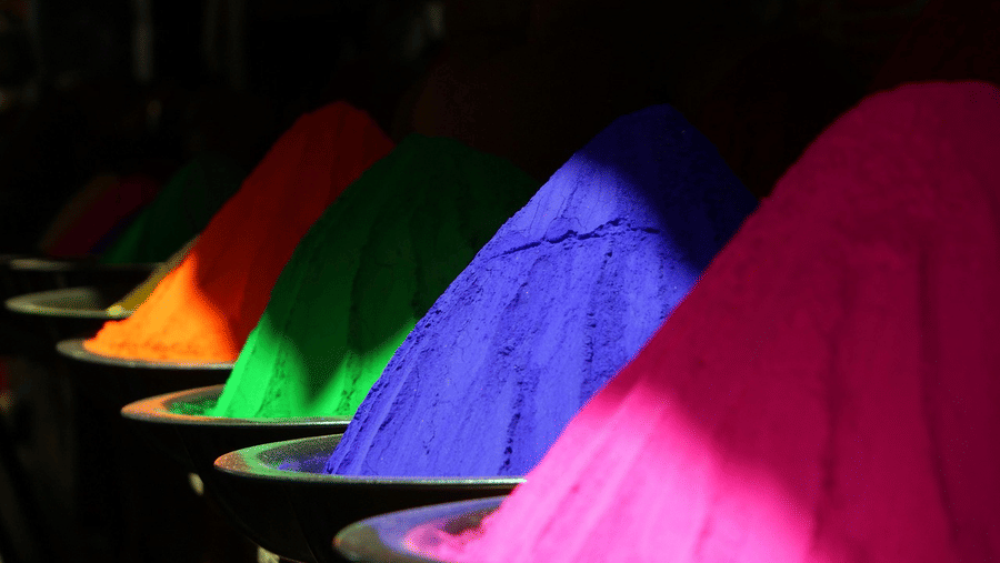 Bright and colorful Holi powders beautifully arranged, ready for the festive celebrations at Ramada Plaza by Wyndham Palm Grove.