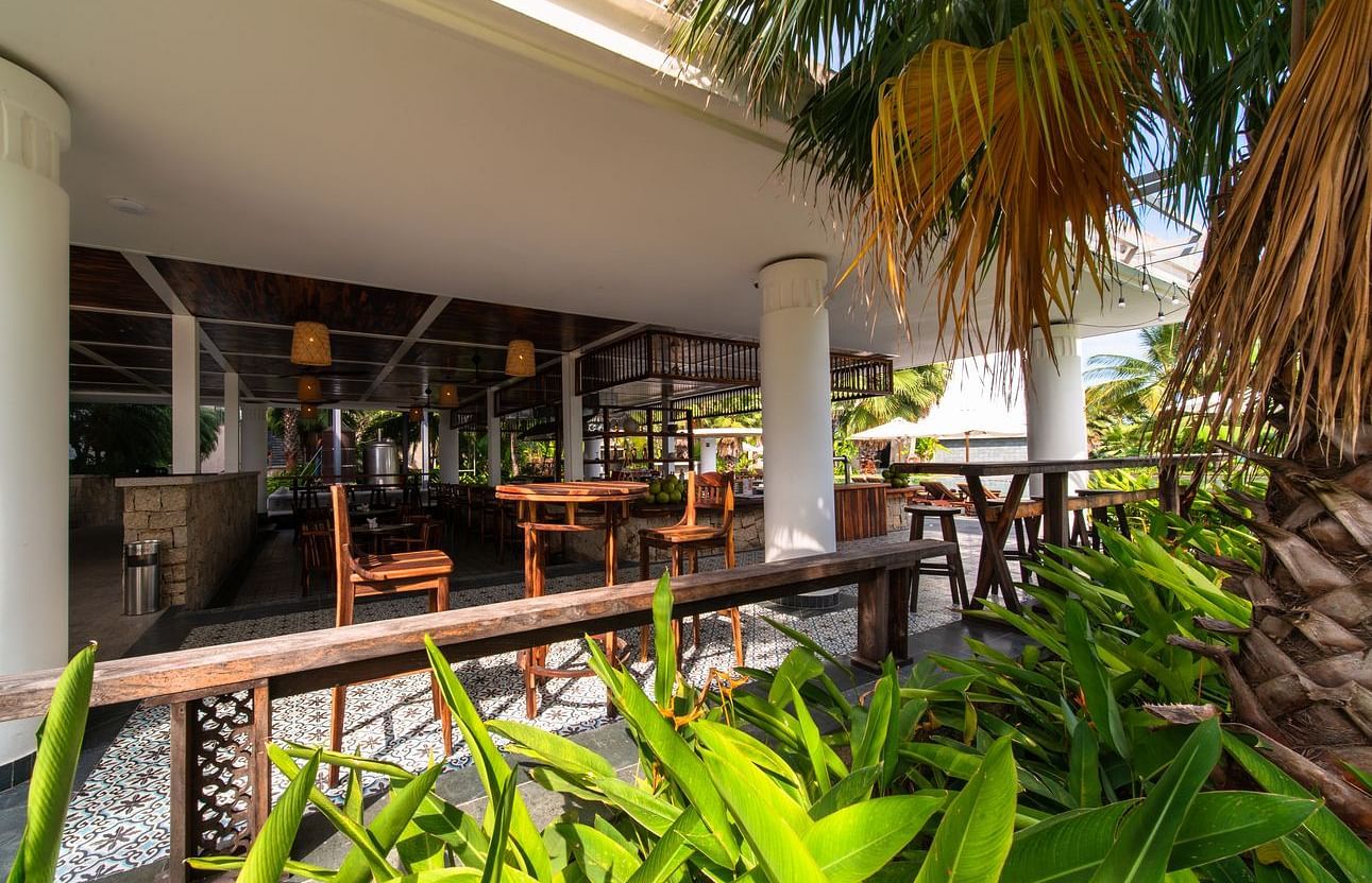 A garden side view of a restaurant seen during a sunny day - Alibu Resort Nha Trang