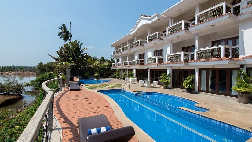Large swimming pool with recliner at White Pearl Resort by Rosetum