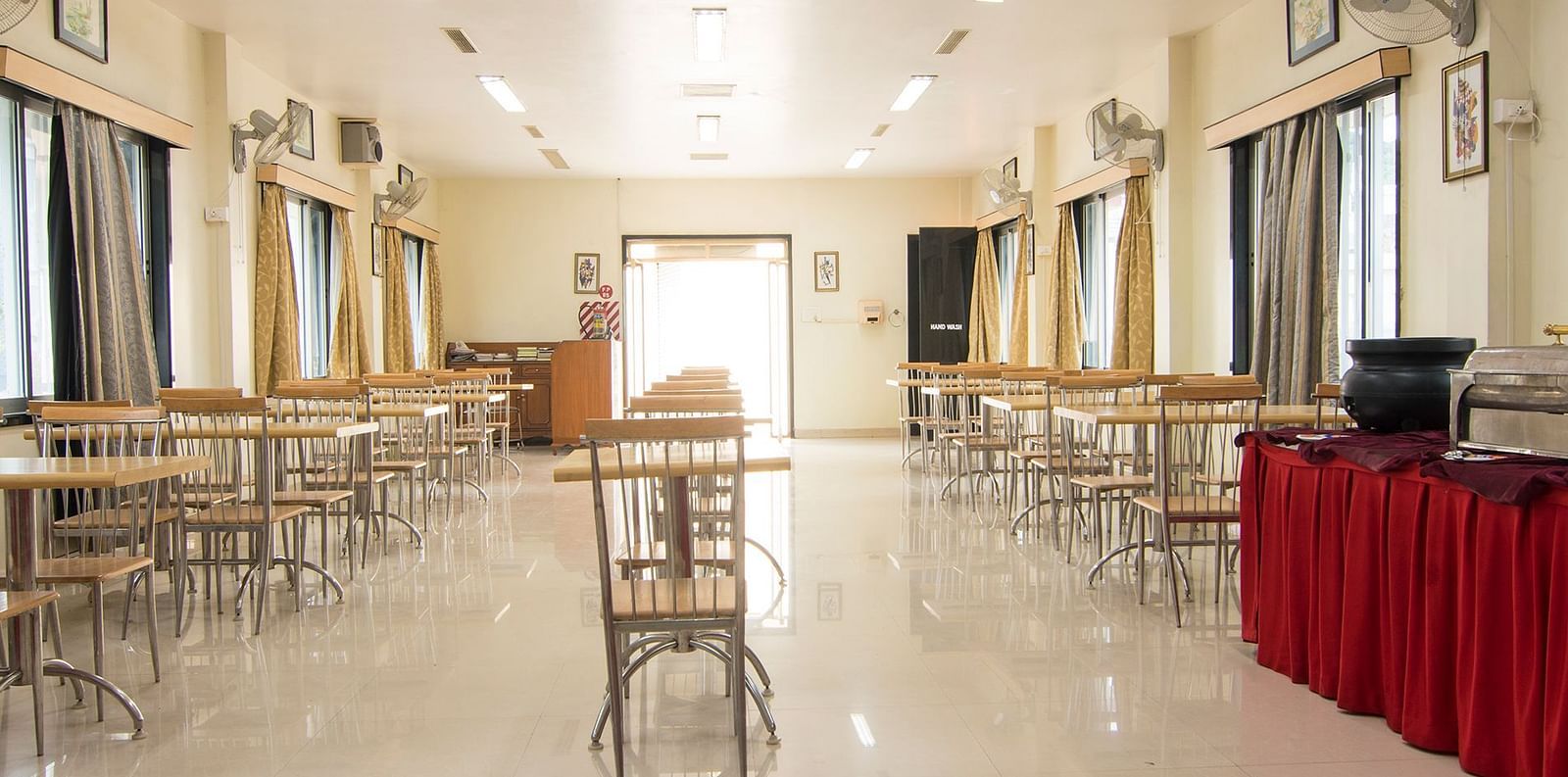 The first conference room image, depicting the arranged seating and podium with a red cloth at Shantiniketan - Budget Stay in Hyderabad near Ramoji Film City.