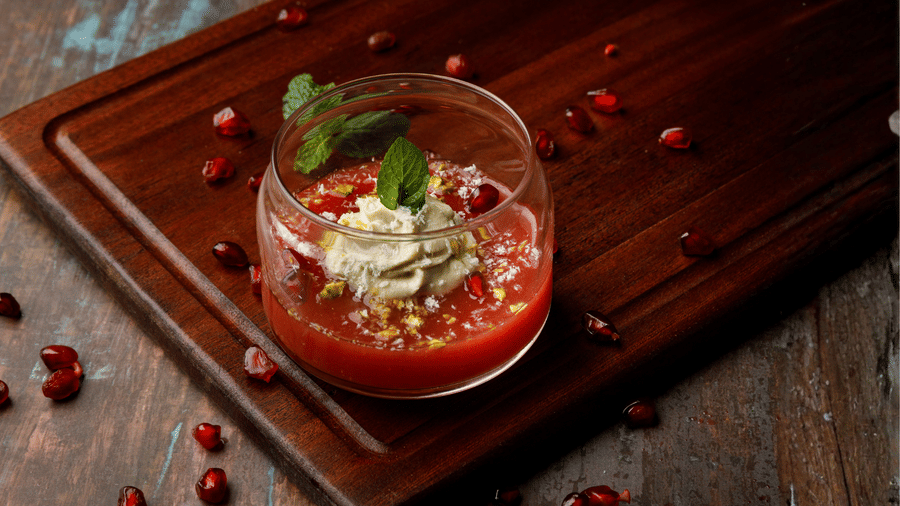 Japanese-style Watermelon Kanten dessert with fresh mint, pomegranate and pistachio garnish.