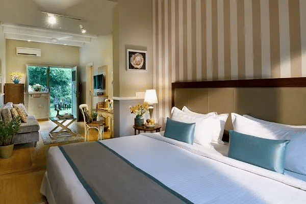 Room with a huge bed, lamps, and a window view at Karma Chalets.