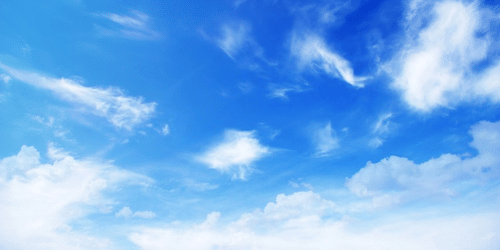 Open sky with scattered clouds creating various shapes