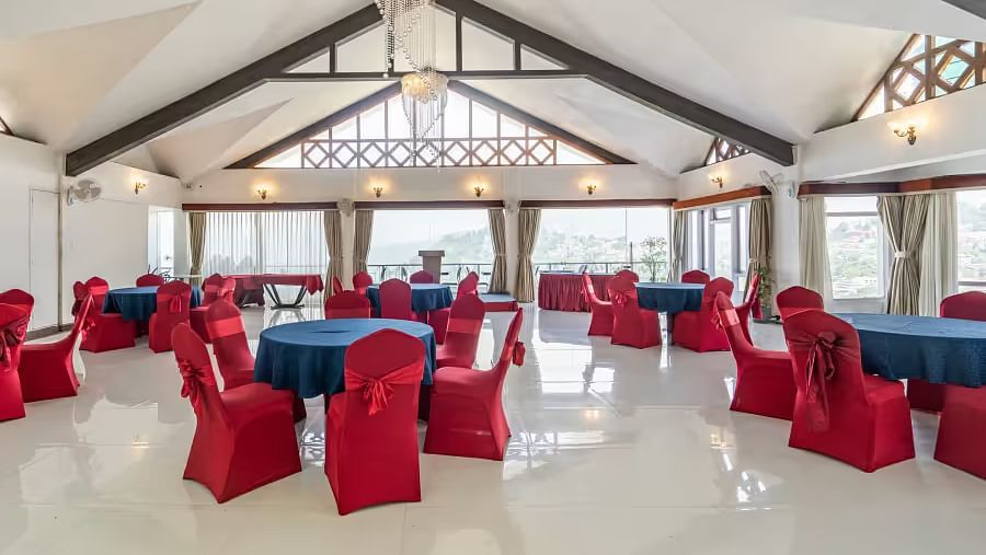 event hall with red chairs and blue table at Summit Lillium Hotel & Spa, Kalimpong