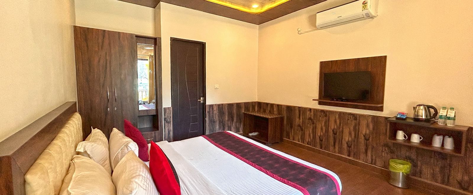 A Luxury Cottage with a large bed in front of the TV at DLS MJ River Resort, Rishikesh.