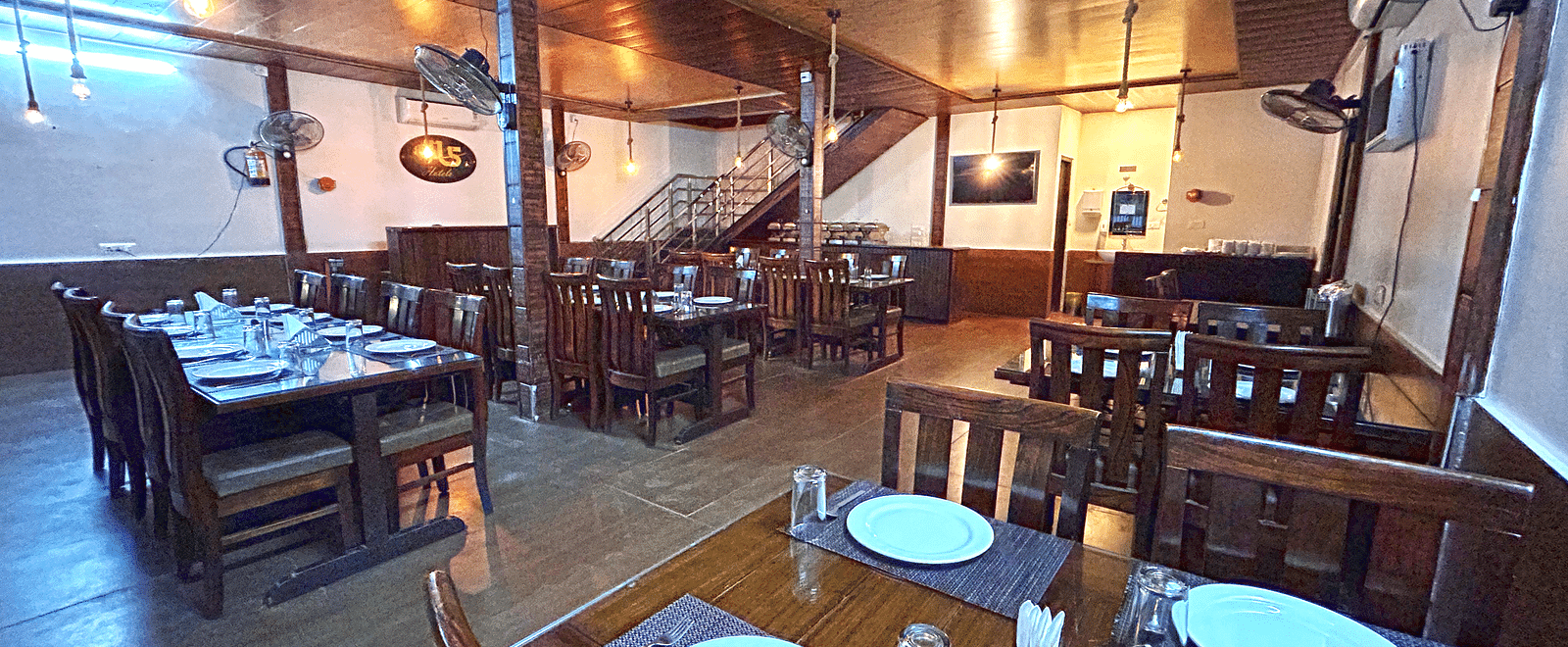 Dining area of the in-house restaurant at DLS MJ River Resort, Rishikesh.