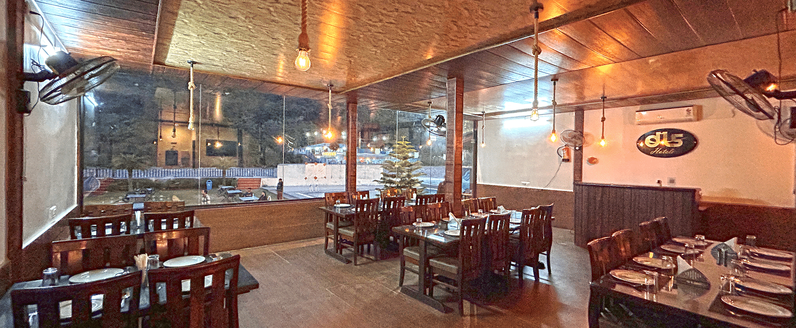 Dining area of the in-house restaurant at DLS MJ River Resort, Rishikesh.