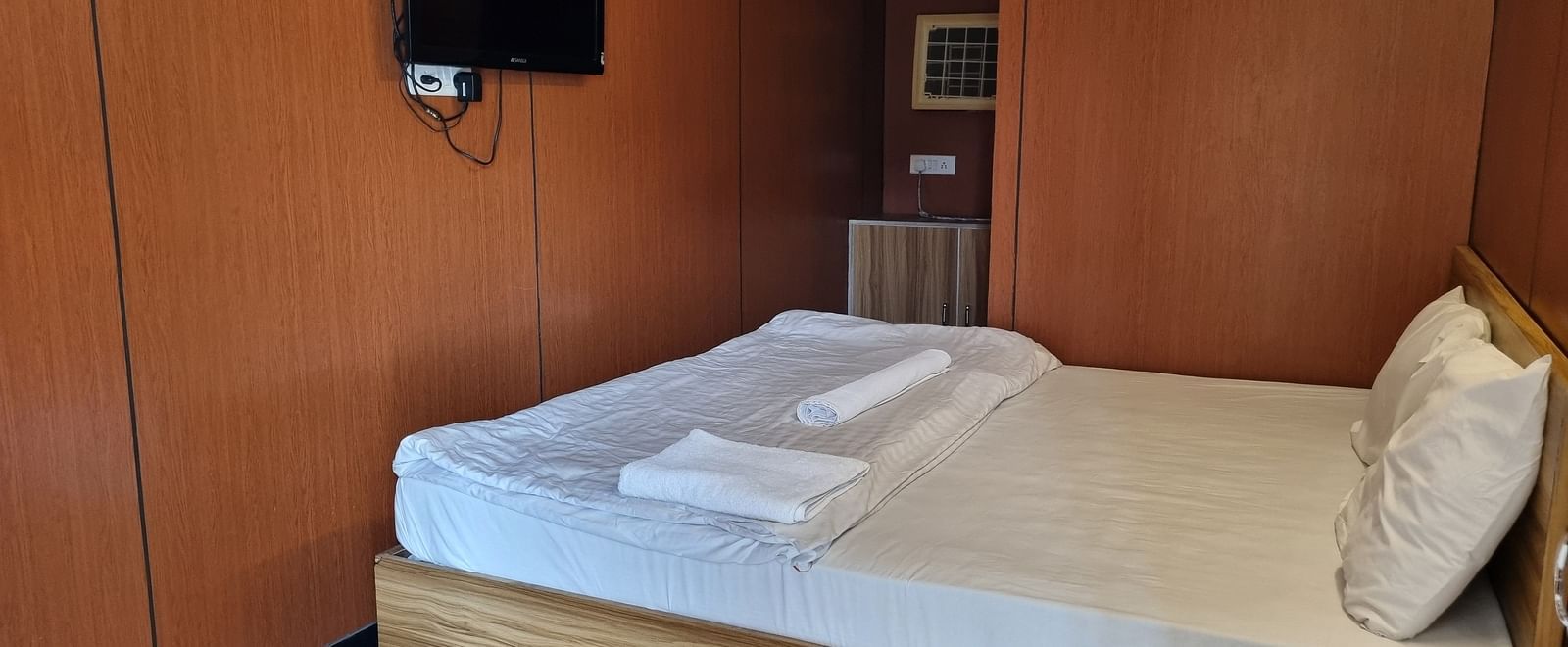 A double bed with pillows and a comforter placed over it at the Dream Vision Guest House.