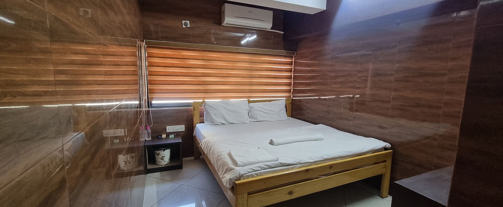 Corner view of the Double Bed Room With Air-conditioning featuring a double bed in the side.