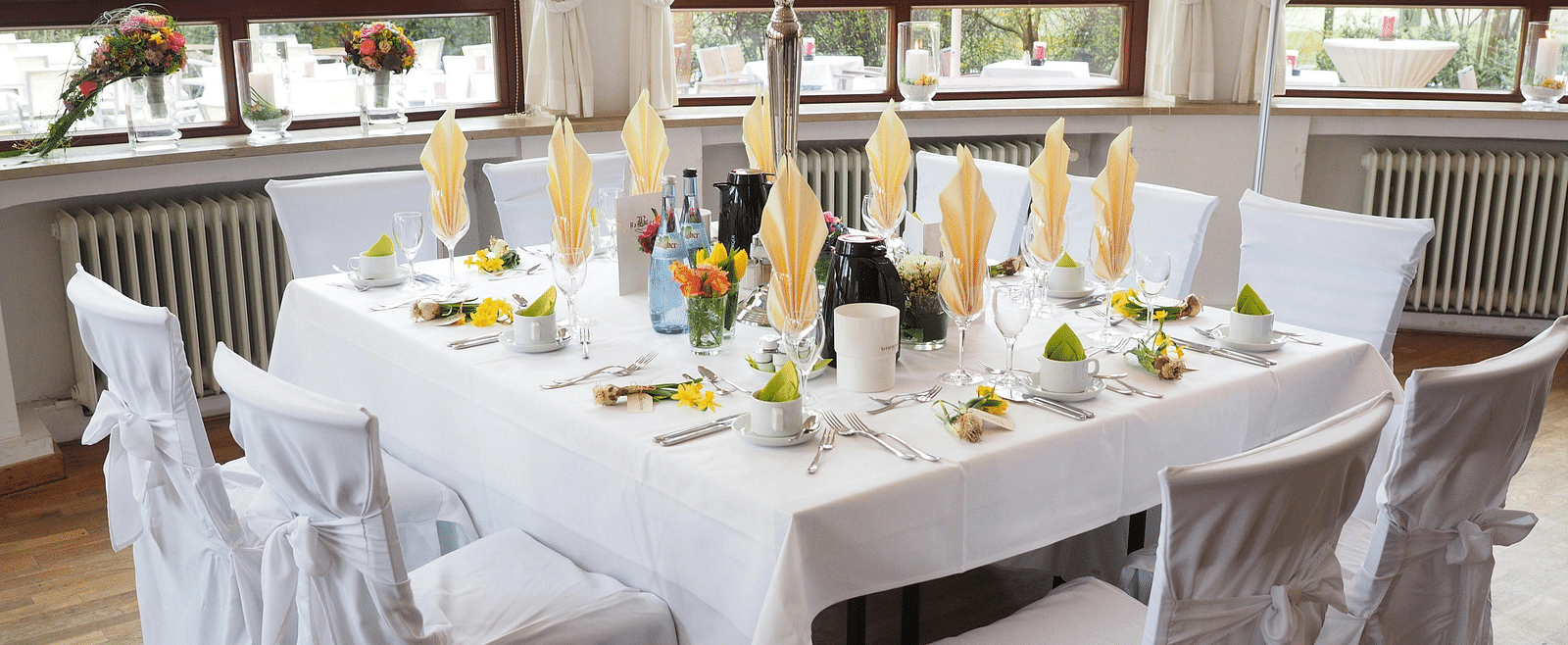 A table and chairs, elegantly decorated and arranged for an event.
