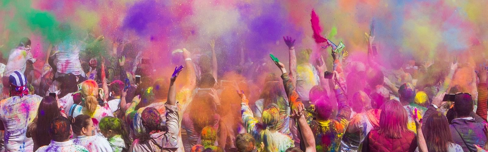 a group of poeple celebration a colourful festival with powdered colours spread in the air3