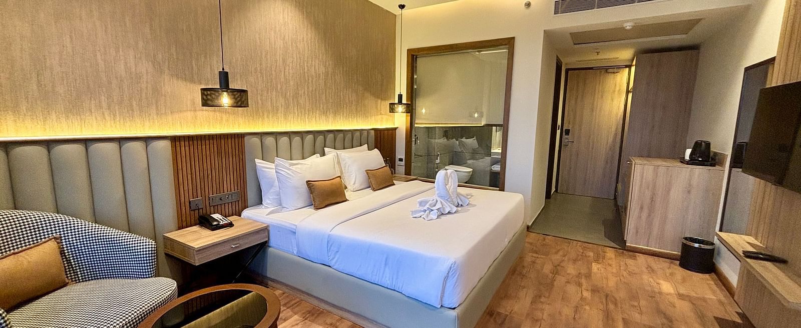 Modern bedroom with twin beds, wooden flooring, and cosy interior décor – ARNISA Boutique Hotel