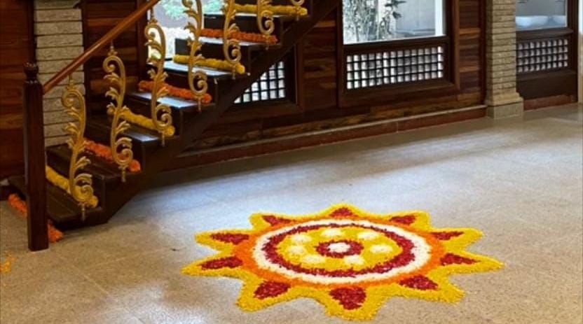 image of a flower rangoli made at the entrance of the tambulam at hoysala village resort in hassan