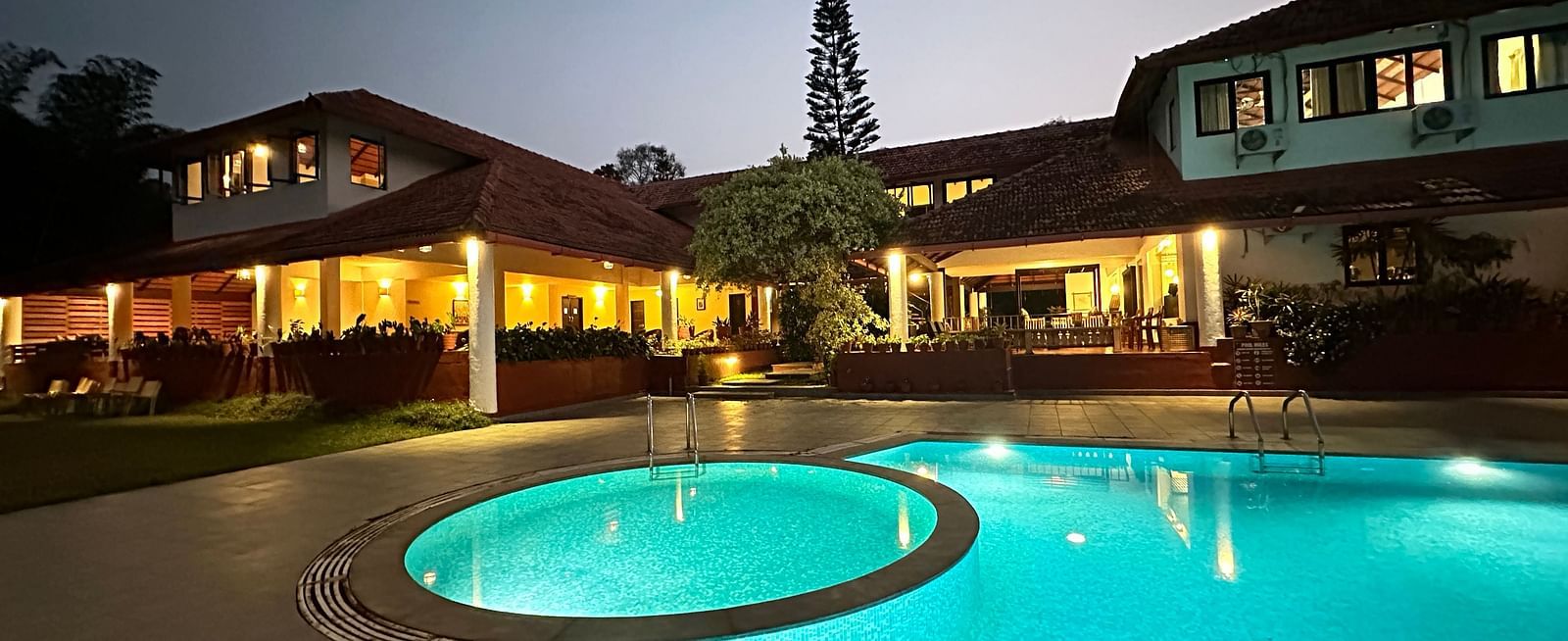 view of a swimming pool with the property in the background - Kadkani River Resort, Coorg