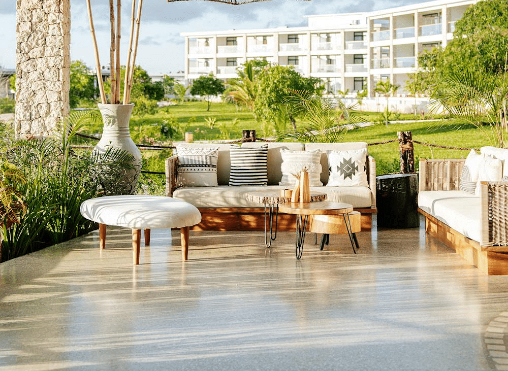 Image of an outdoor seating with sofas with tables in front