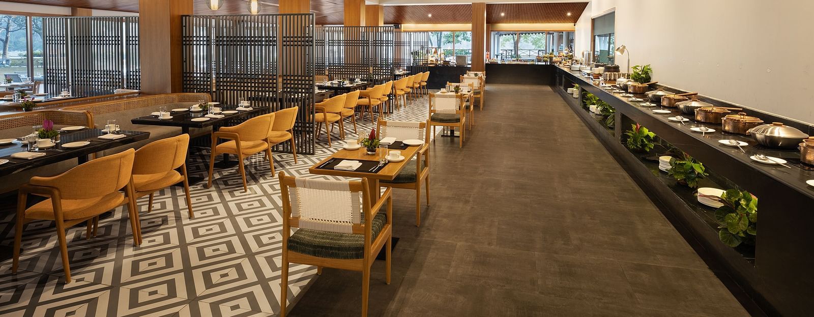 An image of a dining area with chairs and table set and a buffet counter at one side