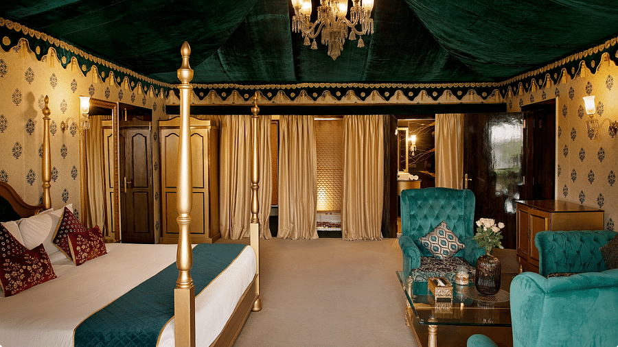 Side view of a room with a bed and a seating area in front at Rajasthali Resort & Spa Jaipur.