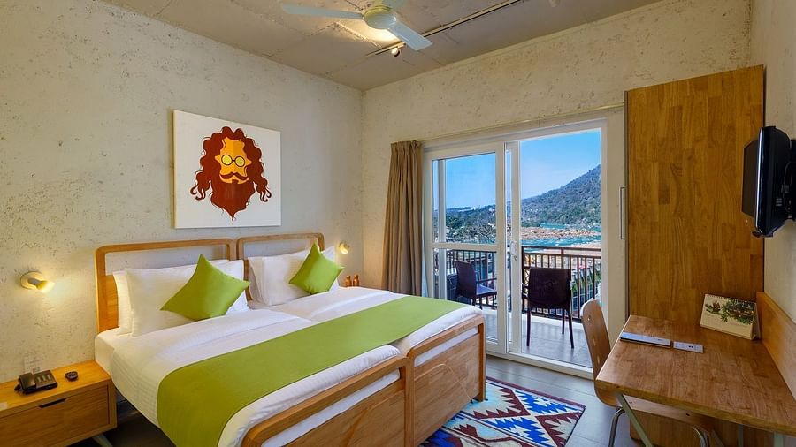 A bedroom with mountain view window at Bedzzz, Rishikesh 
