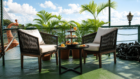 Outdoor patio seating at polo floatel with a coffee table on balcony.